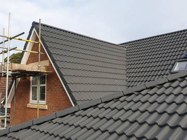 Freshly cleaned dark grey pitched tile roof on a residential property after professional roof cleaning