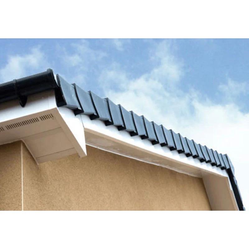 Newly installed gutter and fascia on a pitched roof with dark tiles