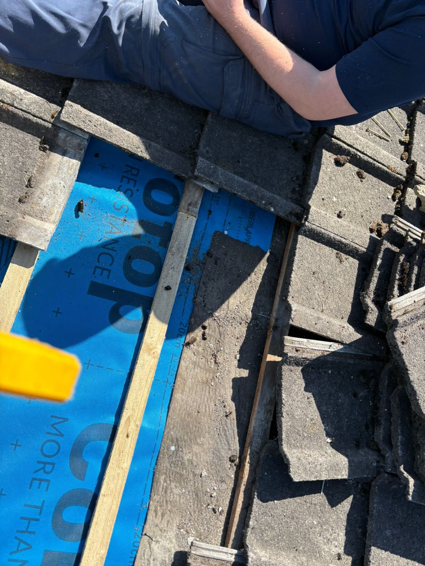 Pitched roof being re-felted and battened during repair